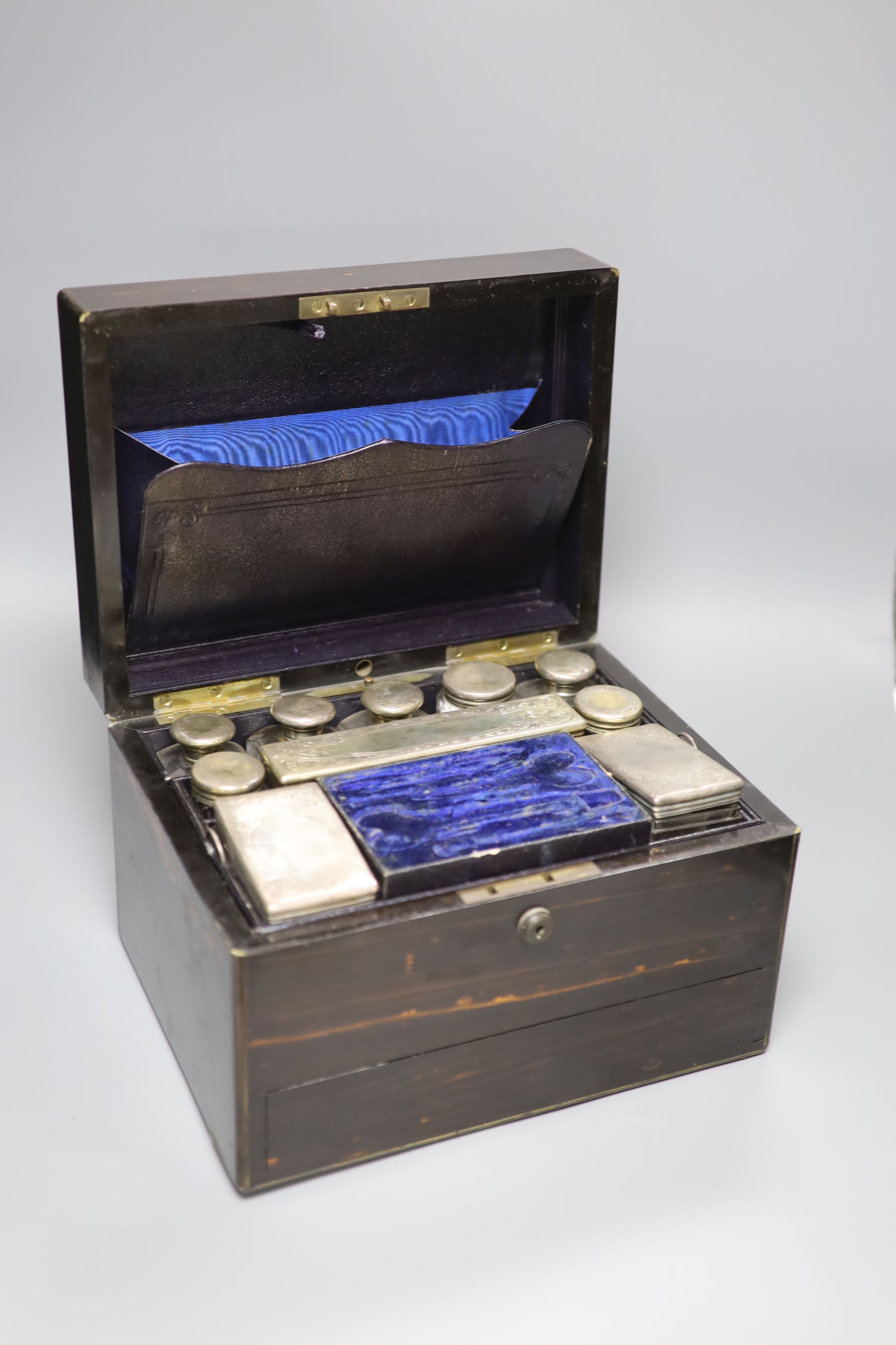 A Victorian coromandel toilet box with silver mounted toilet jars(four lids unmarked), retailed by Asprey & Co,